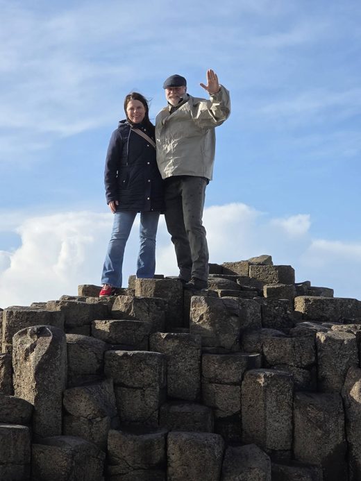 Jon and his wife standing on the basalt columns of the Giant’s Causeway